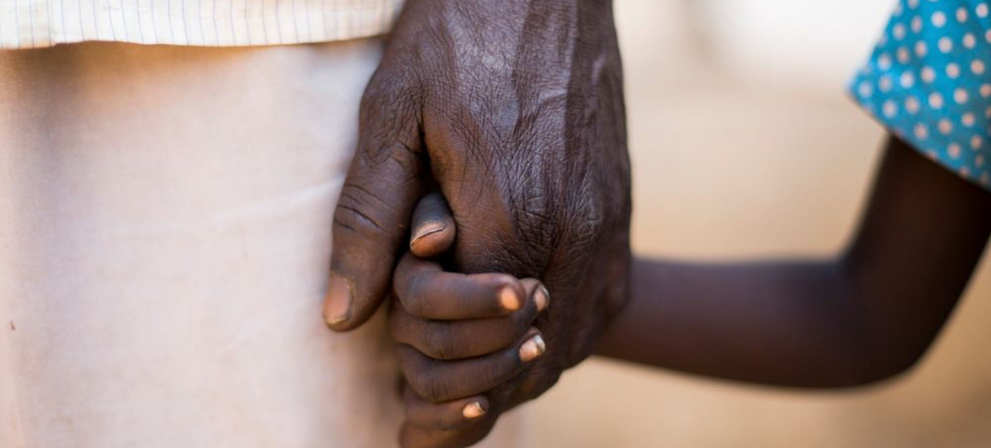 A man holding a child's hand.